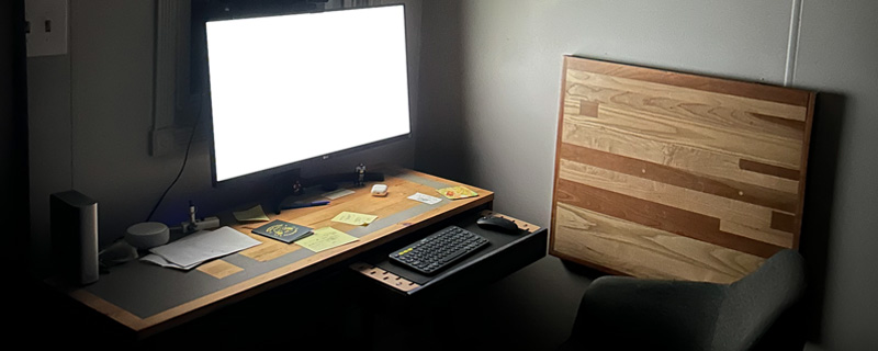 Front view of the desk setup with monitor and keyboard tray